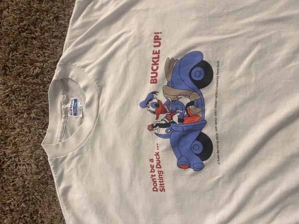 Price check for this vintage 80’s Donald Duck seat belt shirt
