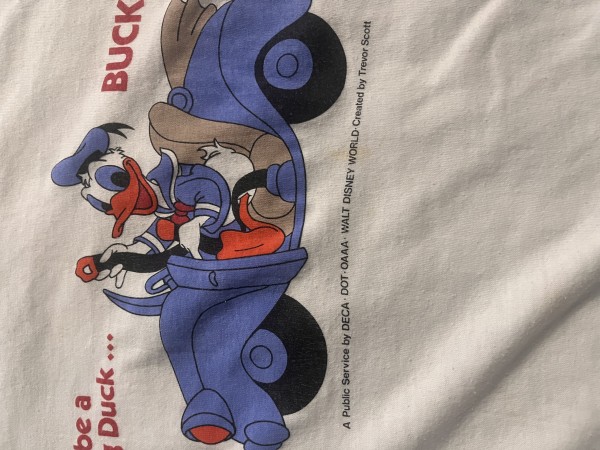 Price check for this vintage 80’s Donald Duck seat belt shirt