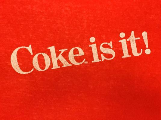 Vintage 1980s Coke Is It Coca Cola Red Slogan T-Shirt S/M