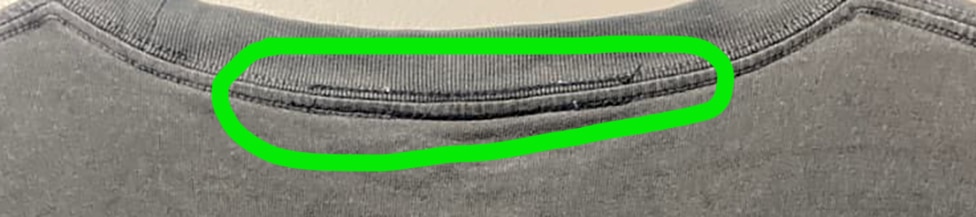 evidence of seam tampering on rear of t-shirt neck