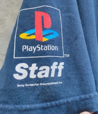 Blue shirt featuring the PlayStation logo and the word 'Staff' printed on it.